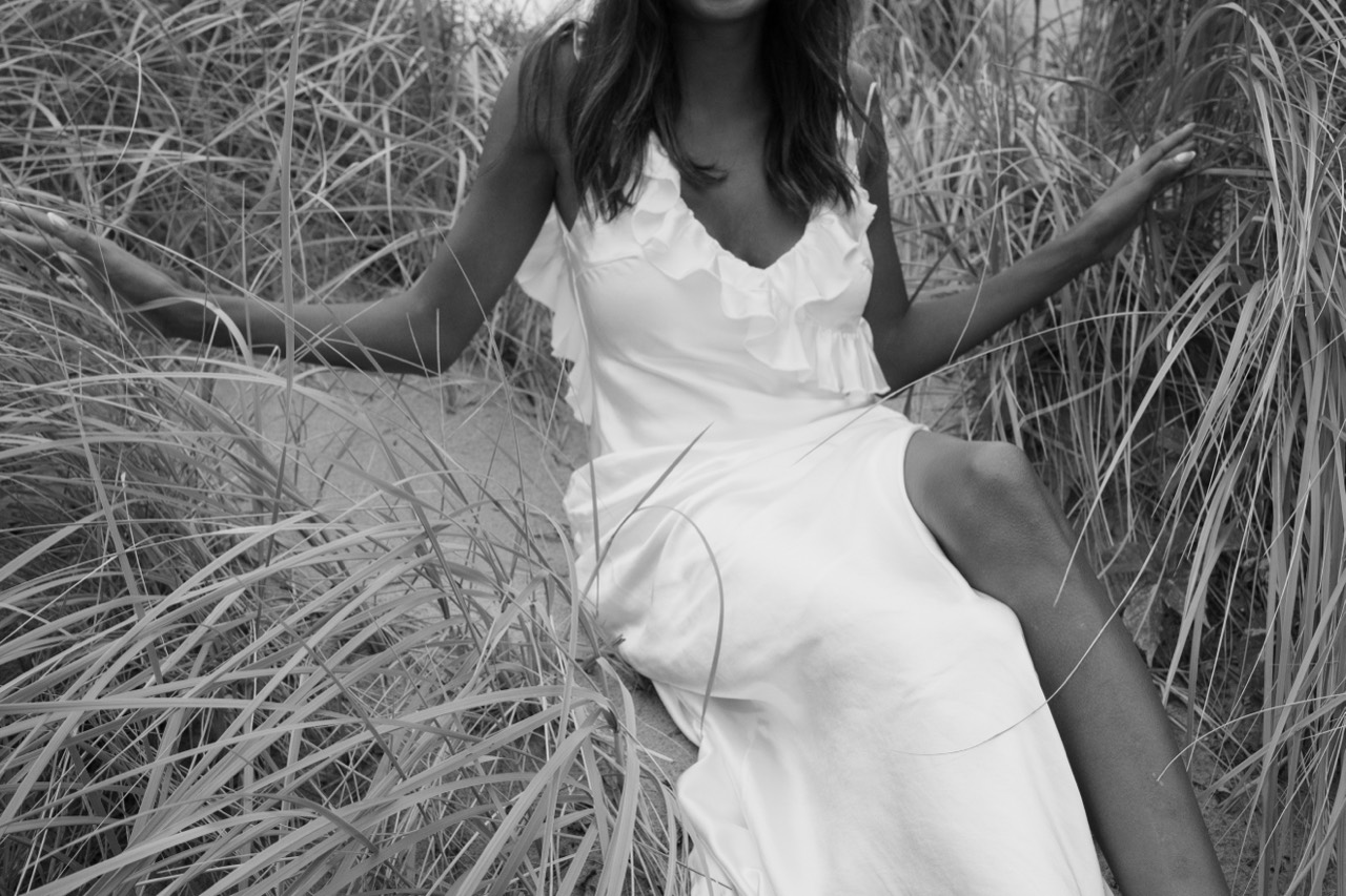 Self love portrait of a woman seated in tall grass